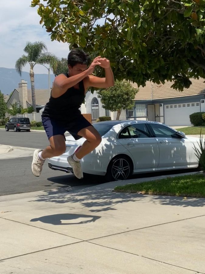 Junior James Rivera completes gorilla jumps in his driveway to stay in shape for baseball. 