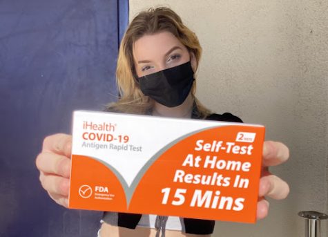 Ashlei Gruender picks up her Covid-19 home tests from the Activity Office