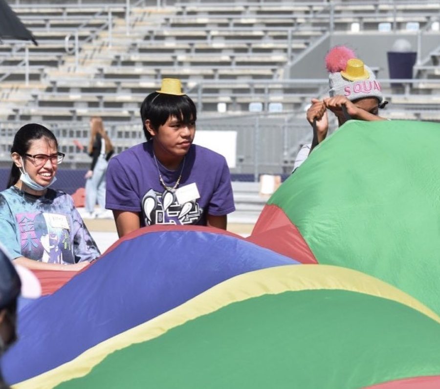 Two special-needs students participate in the parachute activity. 