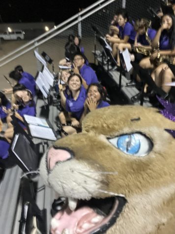 The Marching Cougars take a selfie with the mascot at the football game