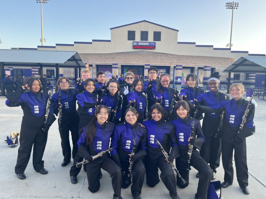 Members of the Marching Cougars pose for a quick photo before performing in the parent preview.  

