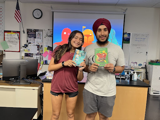 UNICEF officers Alexa Romero and Navdeep Takher proudly show off the donated children's books 

