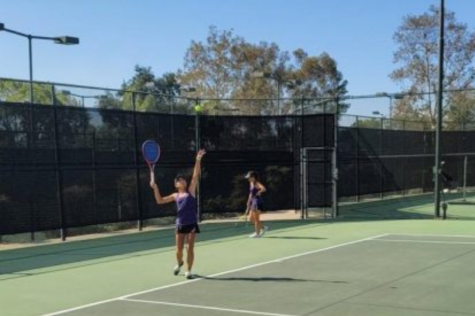 RCHS tennis players practice their serve to compete in matches. 