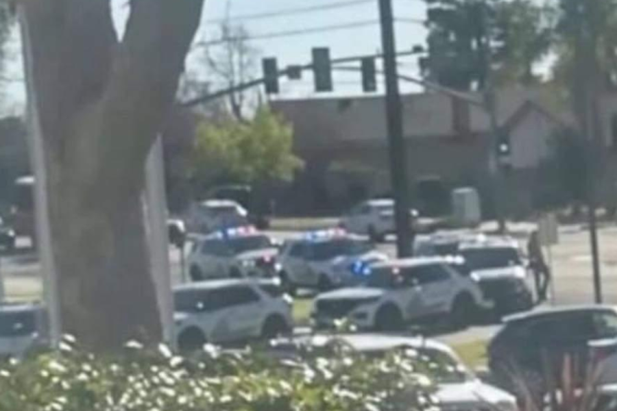 Cop cars and SWAT teams swarm Alta Loma High School.