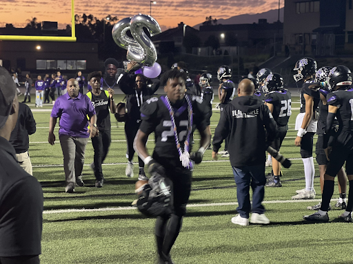 Roman Pearce runs to sidelines on football senior night.