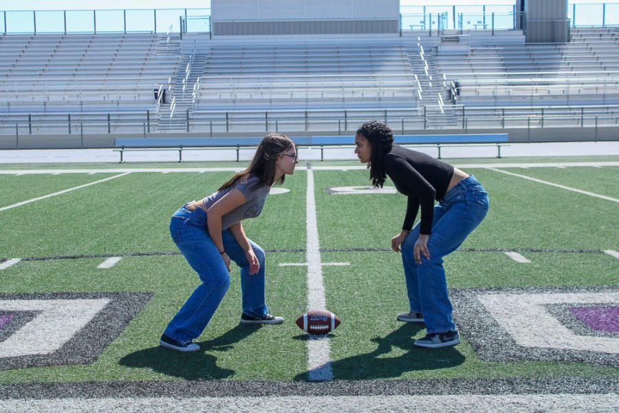 Junior Isabella Moran and senior Sofia Vasquez prepare to battle it out on the football field for the Powder Puff football game. 