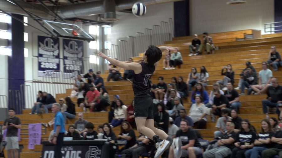 Senior+Vincent+Hwin+leaps+in+the+air+to+return+the+volleyball+over+the+net.
