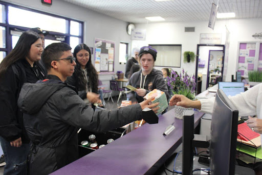 Practical Program students participate in the Cougar Cart. Each student assumes jobs such as "cart-pusher” and “greeter" to practice vocational skills.