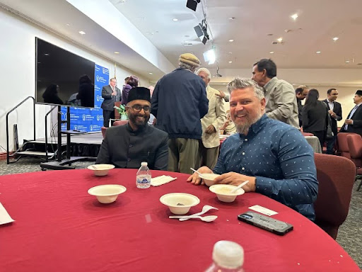 Imam Mahmood Kauser (left) sitting with guests during Ramadan Annual Interfaith Dinner in Baitul Hameed Mosque.