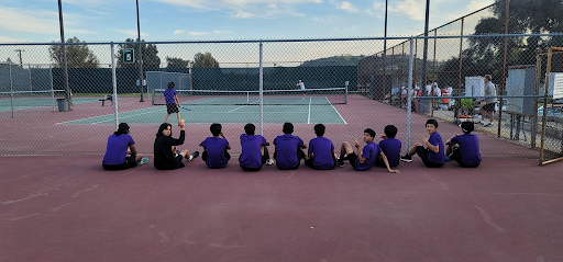 Varsity boys watch a tough singles match against Upland.
