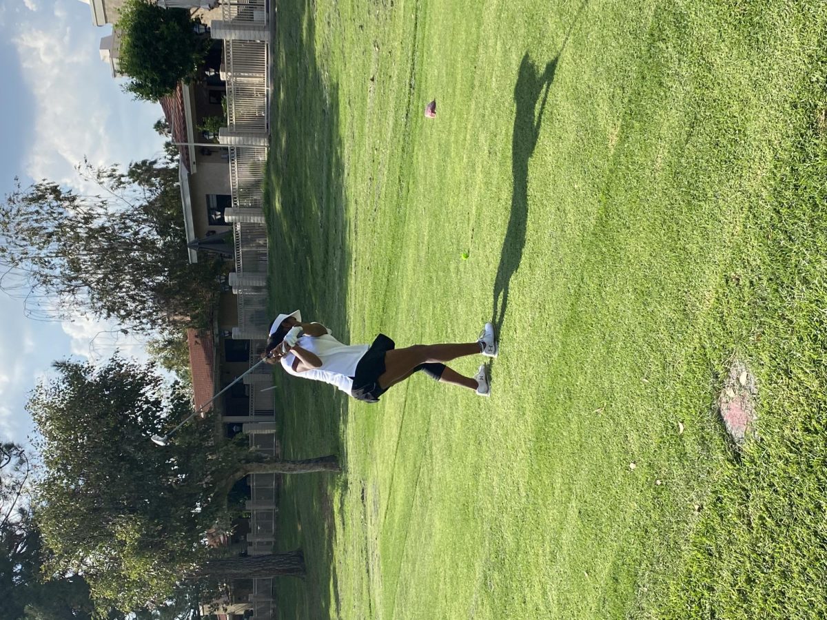 Girls golf athletes practicing at a golf course during the 2022-2023 golf season.