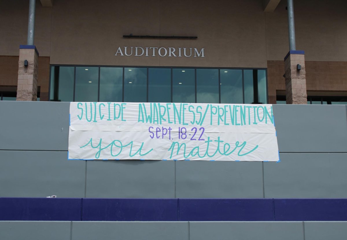The banner made by RCHS Peer Counseling hangs in the quad to bring awareness to Suicide Prevention Week. 