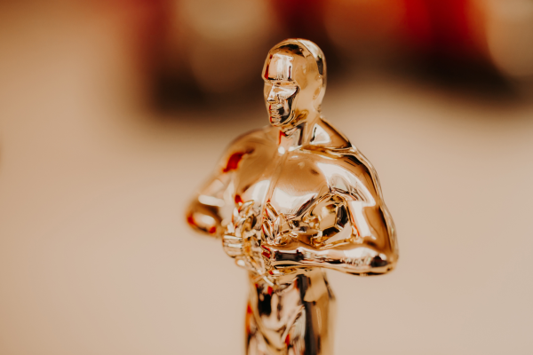 An Oscar shining brightly with a blurred background