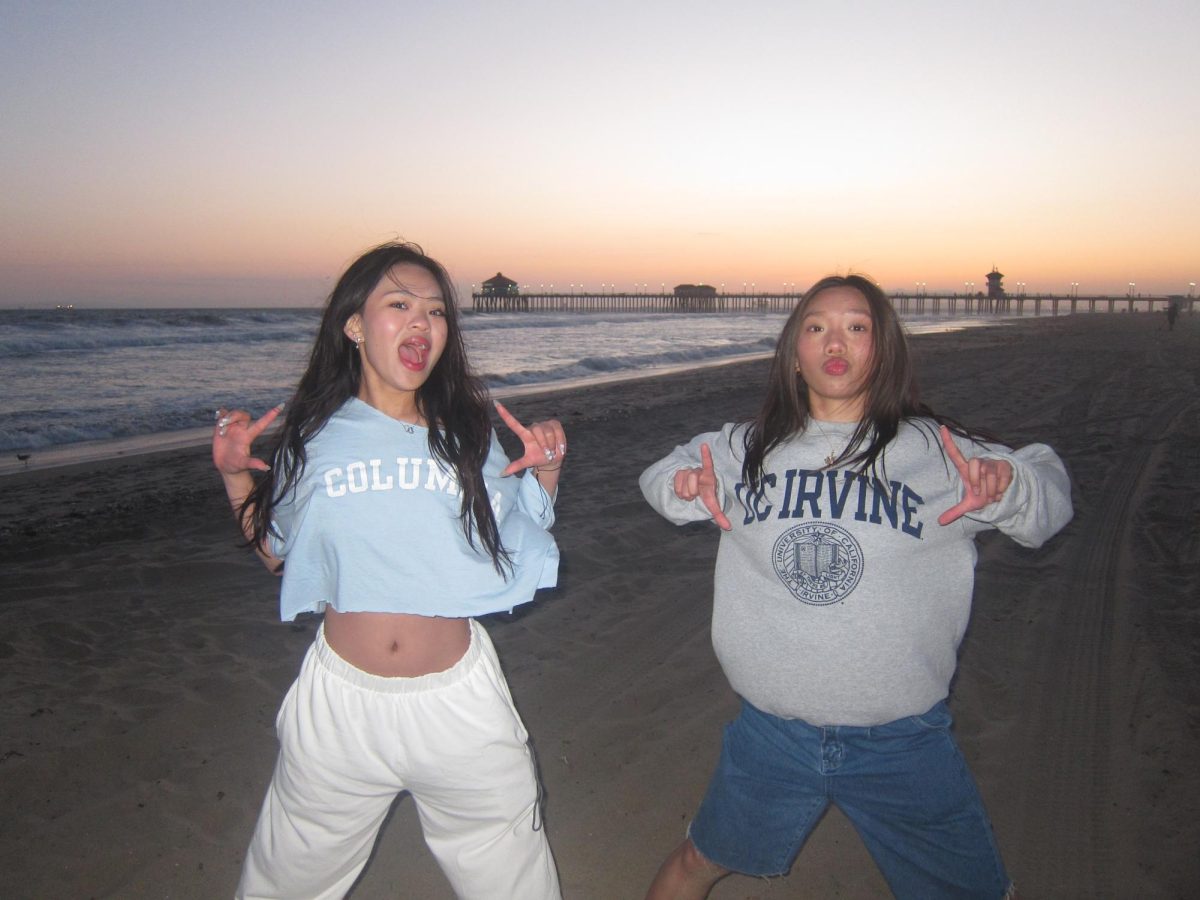 RCHS+seniors+Arlene+Zhao+and+Tiffany+Chu+pose+with+their+college+gear+at+the+beach.+Both+Zhao+and+Chu+took+AP+classes+in+high+school.+