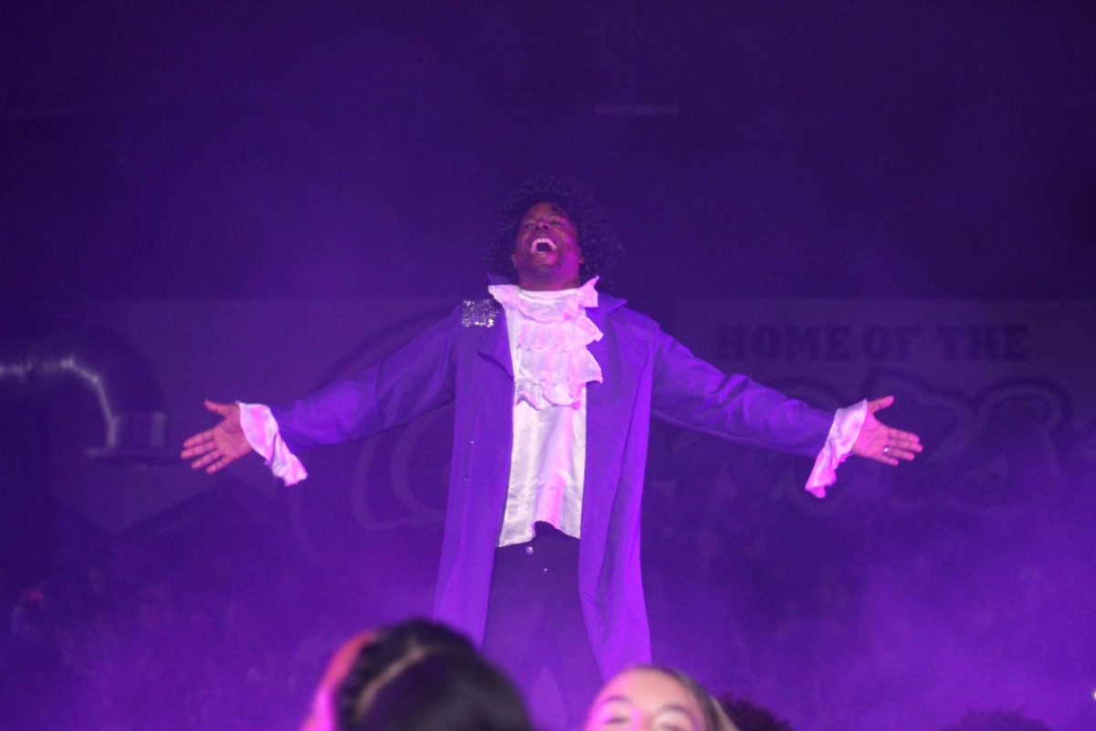 Principal Azande Aikens performs as prince in the final moments of the prom rally. 