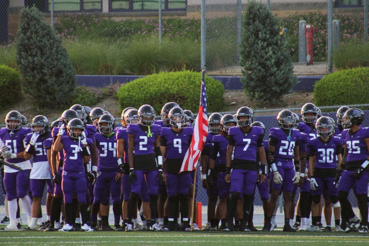 The RCHS Varsity football team prepares to run out on the field at this seasons first football game.