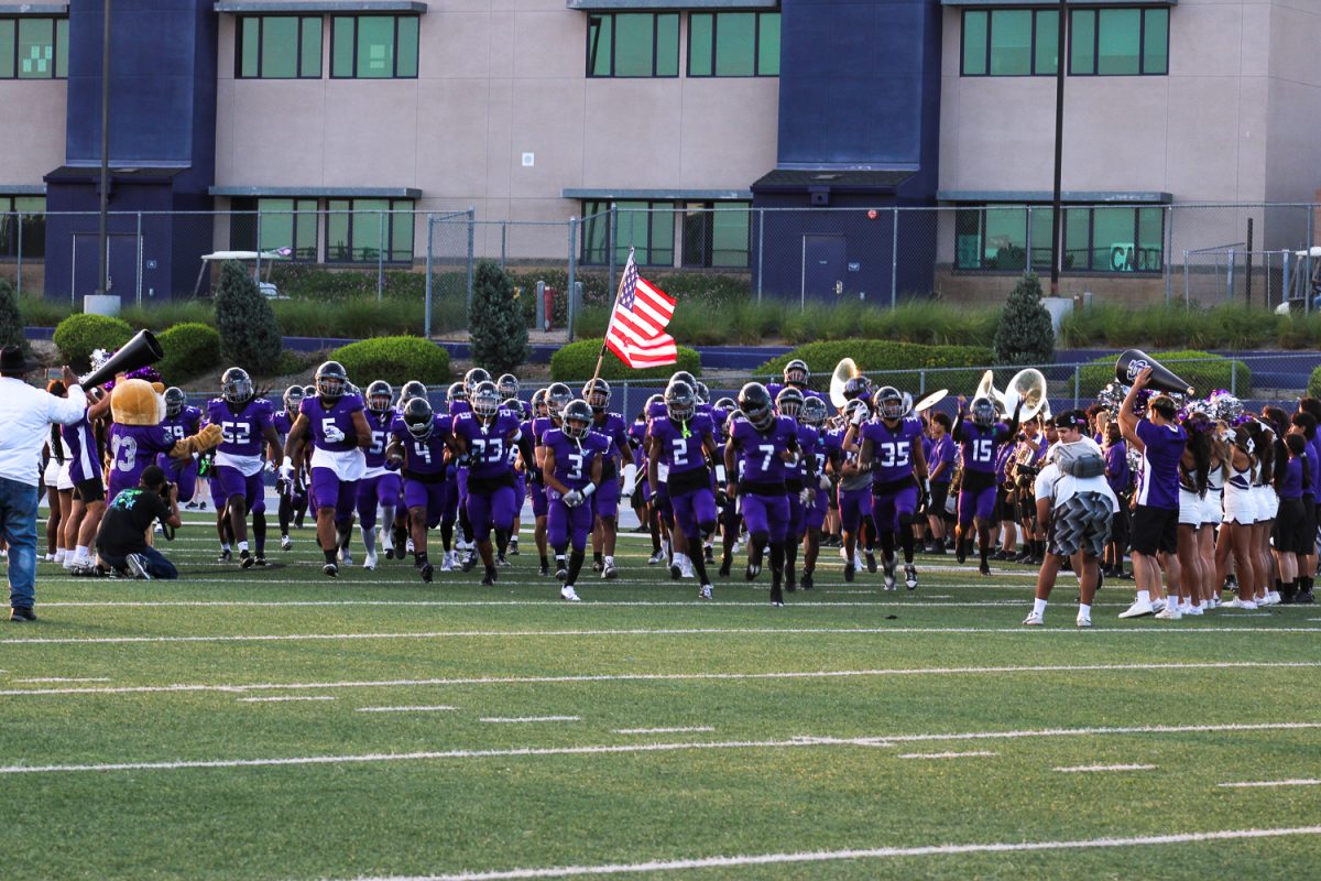 The Rancho Cucamonga High School Cougars run onto the field for the first football game of the season. 