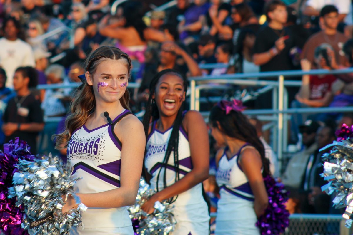 RCHS cheerleader Emily Perea looks onto field at the RCHS first football game.