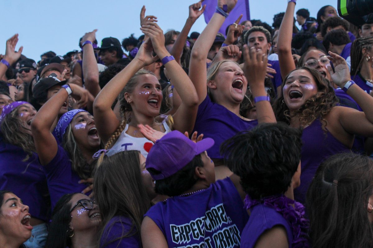 First home football game, students sing in the student section.