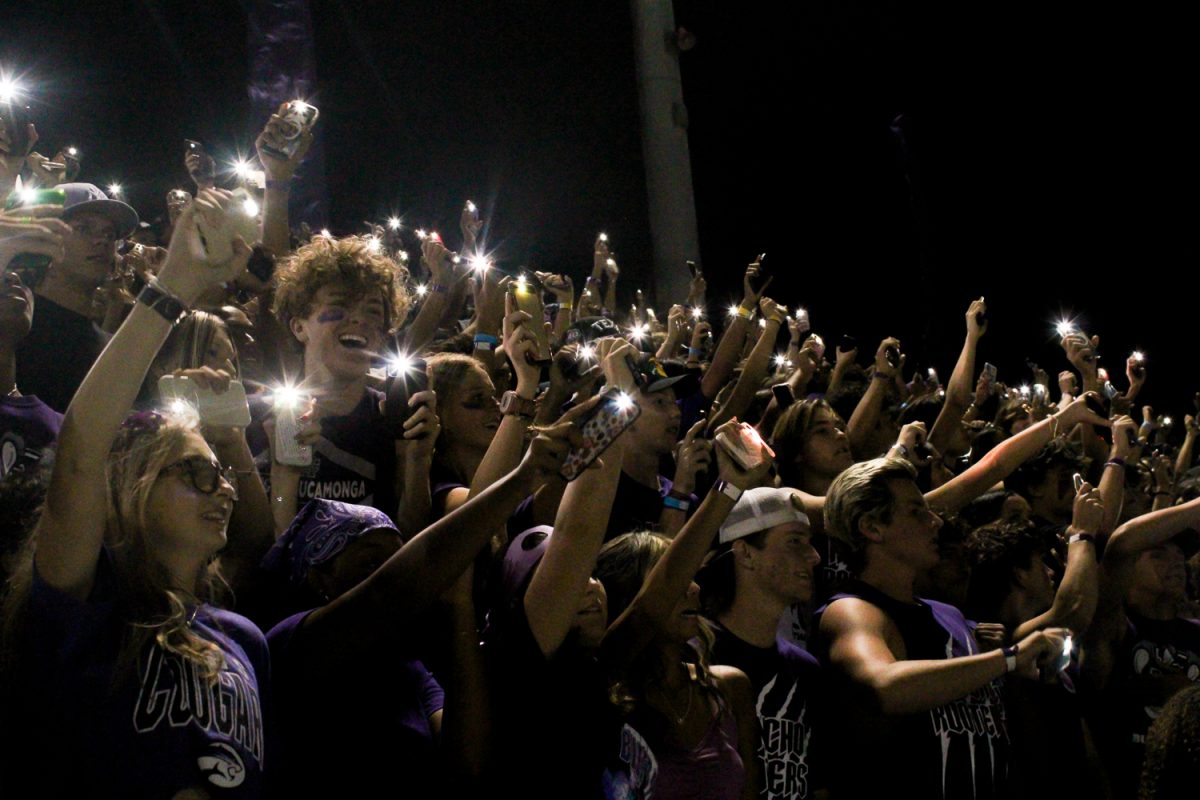 Students light up the student section at the first home football game.