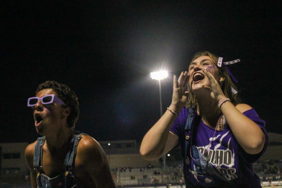 Harley Mathews and Nolan Koopman rile up the student section during the first home football game.