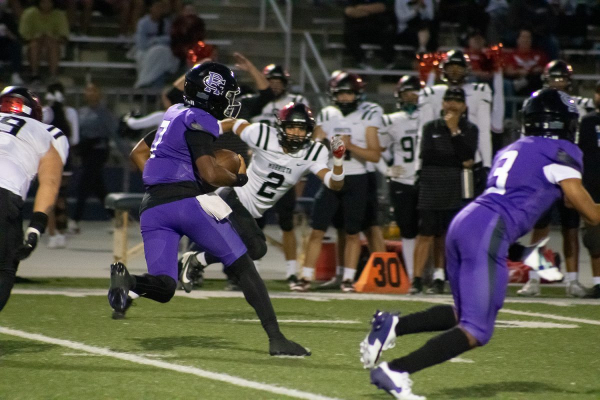 Junior Jacob Chambers runs with the football to make a touchdown.