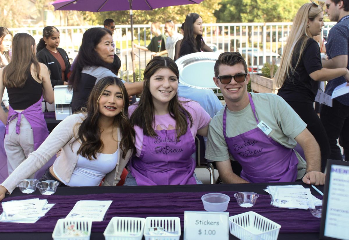 Senior Alessandra Leyva, junior Jolie Jensen, and senior Evan Miles pose for a picture while taking orders for Buddies Brew.