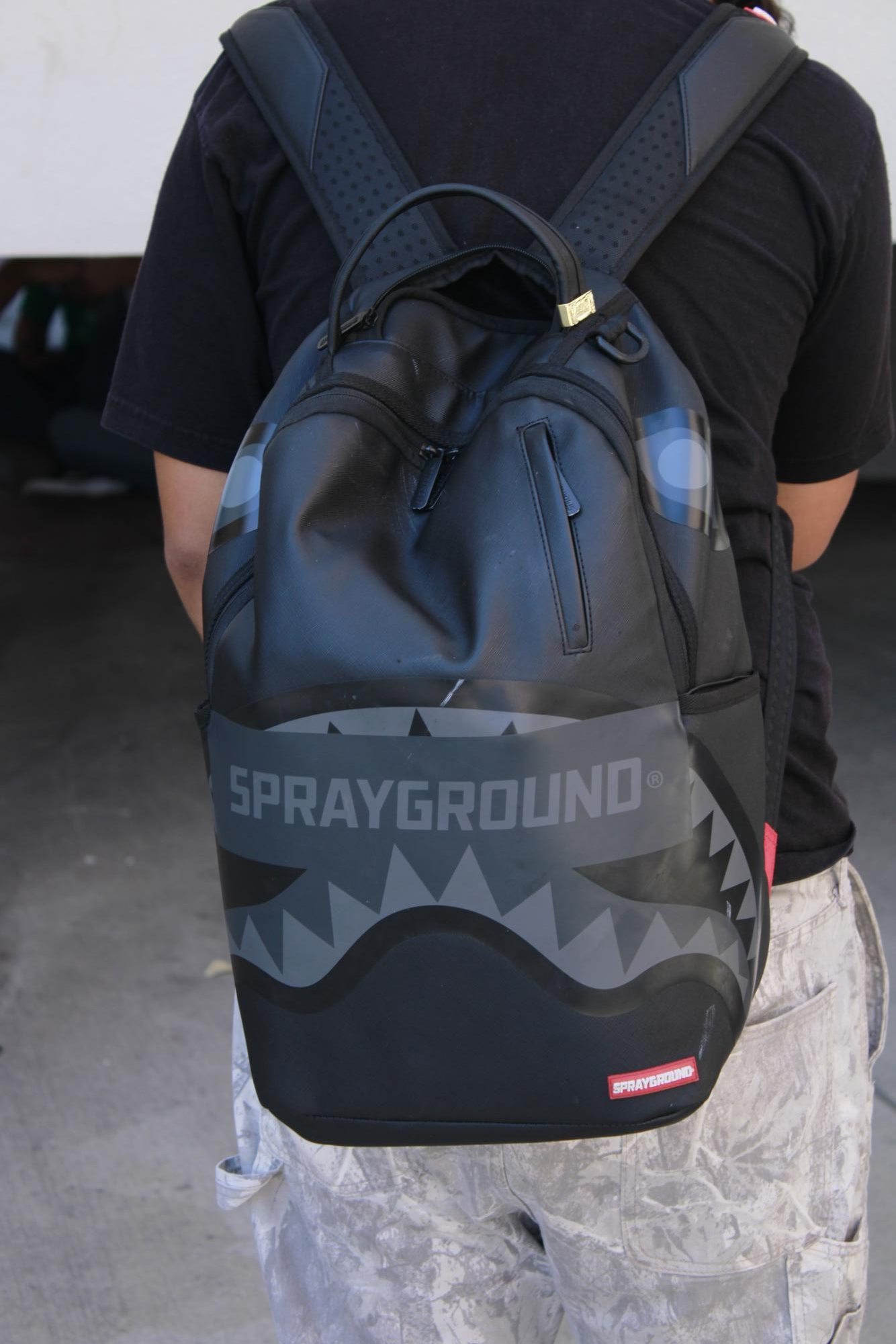 Jose Arteaga models his Sprayground backpack.