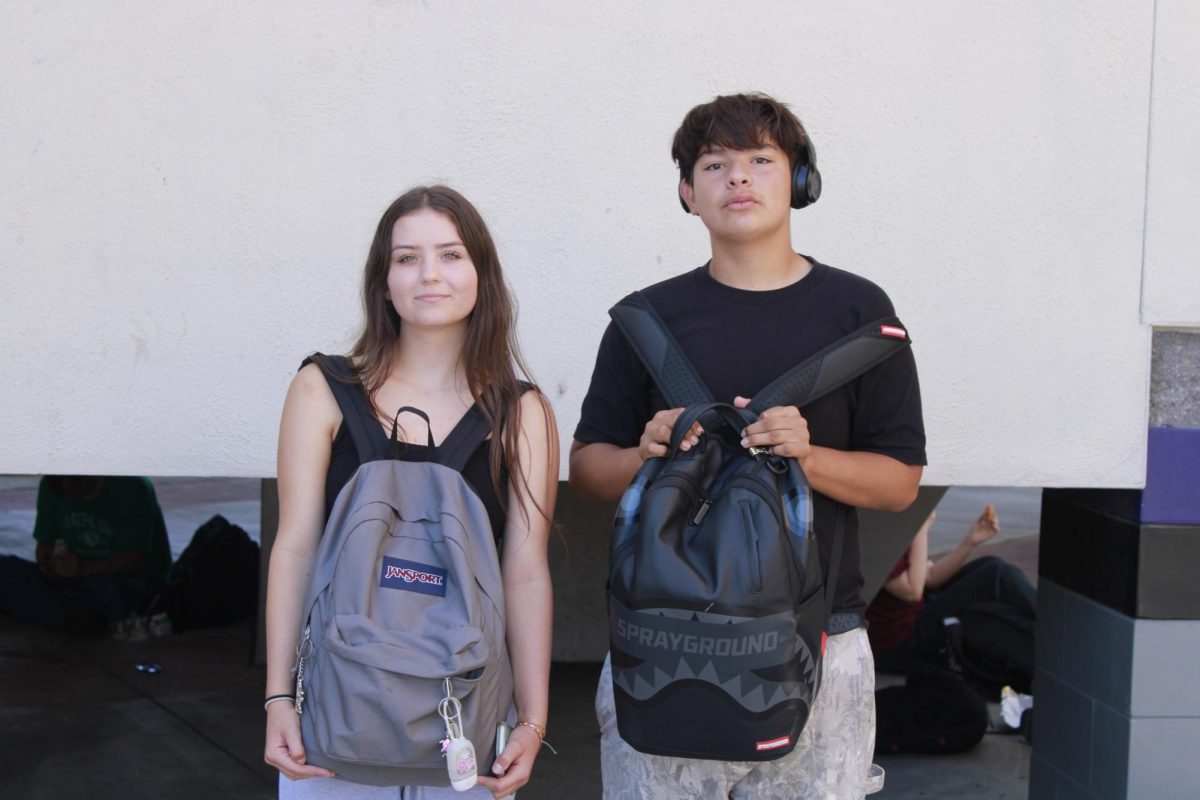 Freshmen Jacey Marginson and Jose Arteaga display their JanSport and Sprayground backpacks. 