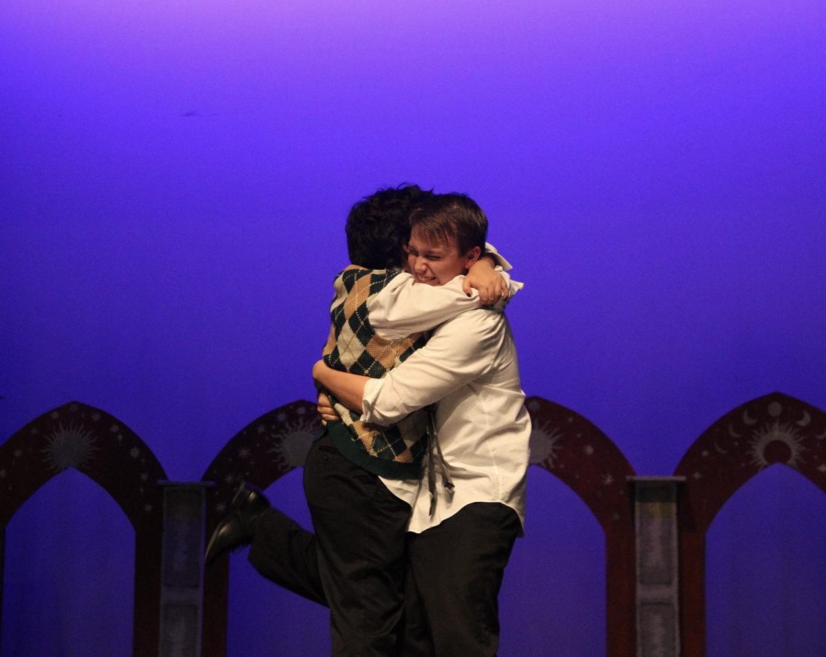 During curtain call, Senior Sophia Garcia Lopez and sophomore Elliot Hernandez hug as they say goodbye to the production.