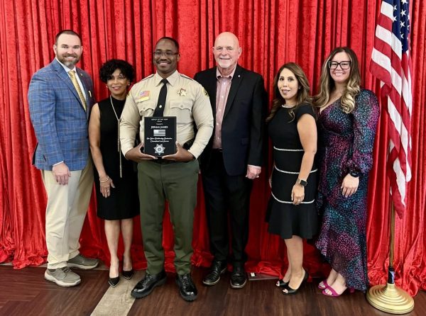 Deputy James holding his plaque that was awarded to him by the Rancho Cucamonga Police Department at the ceremony. 

Photo Courtesy: Deputy James.

Credit to the RCPD.