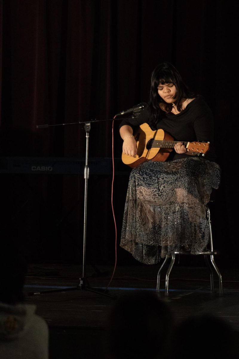 Senior playing guitar and singing 