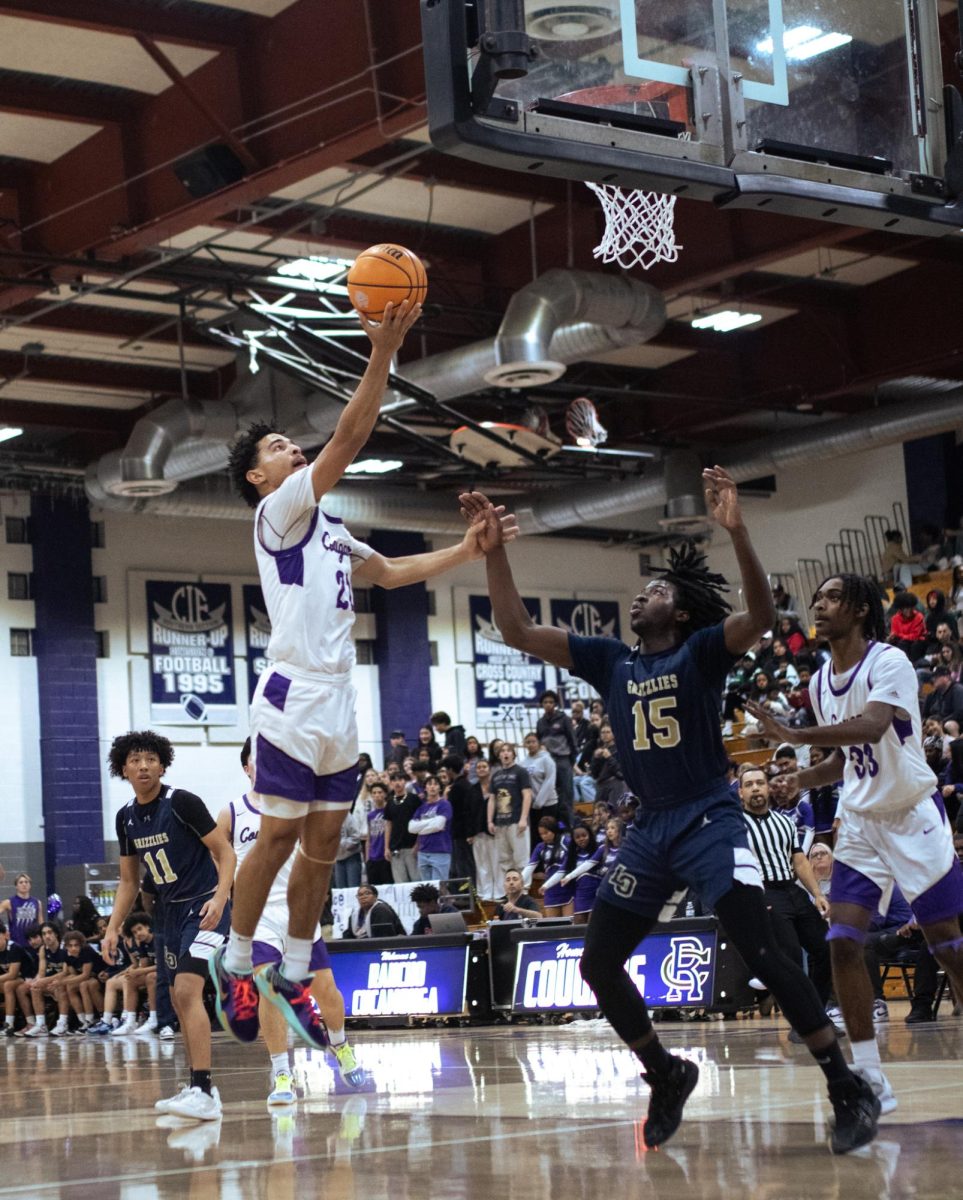 RCHS senior Aaron Glass  attempts a layup over a Los Osos defender.