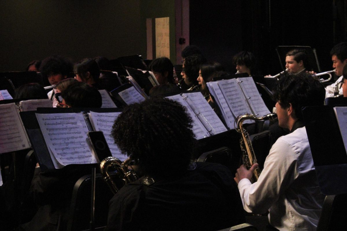 The concert band warms up and tunes for their section of the concert.