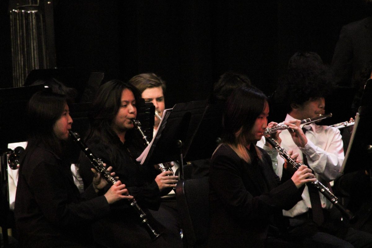 Woodwinds of the concert band play their parts together.