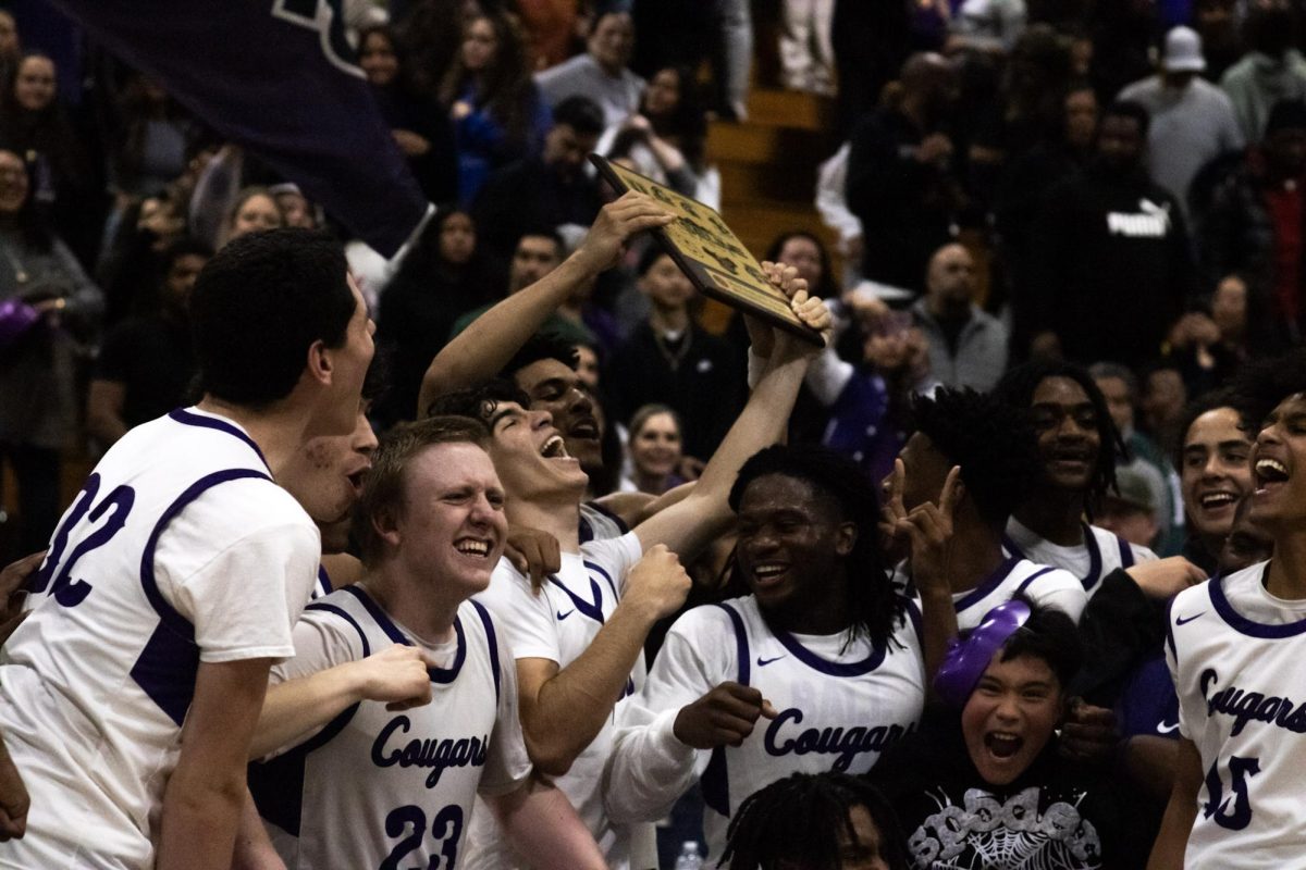 2024-2025 RCHS boys basketball team celebrate winning the Baseline league championship.