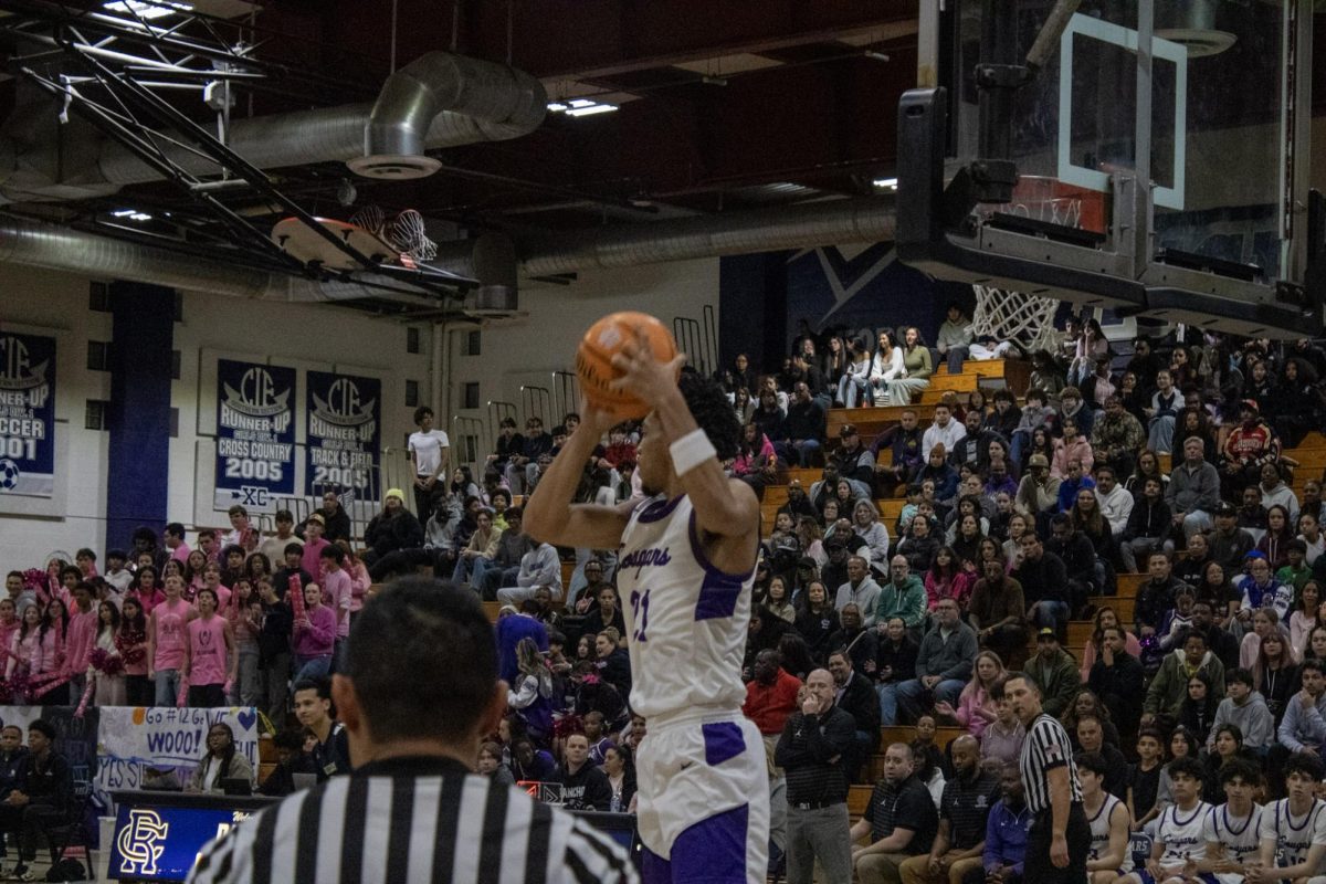 Senior Aaron Glass gets a rebound against the Los Osos High School varsity basketball team.