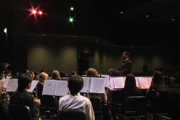 Band director, James Ana, leads warm up for the first year band called symphonic band.