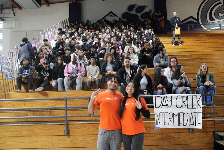 Jordan Bonner and Makalya Flores pose in front of Day Creek students.