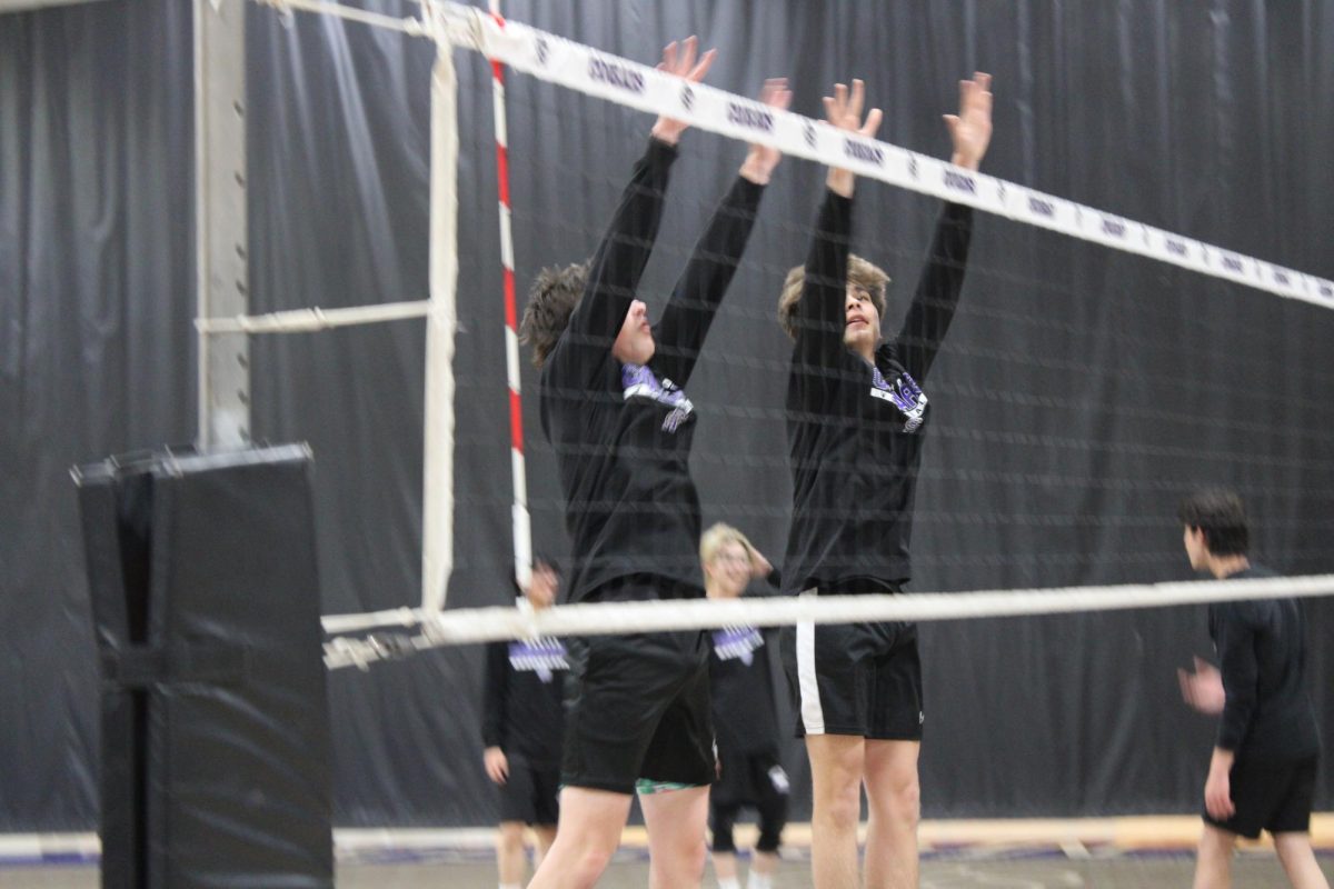 Juniors Mikko Bawaja and Aydan Wheeler warm up with blocking over the net before their fist home game.