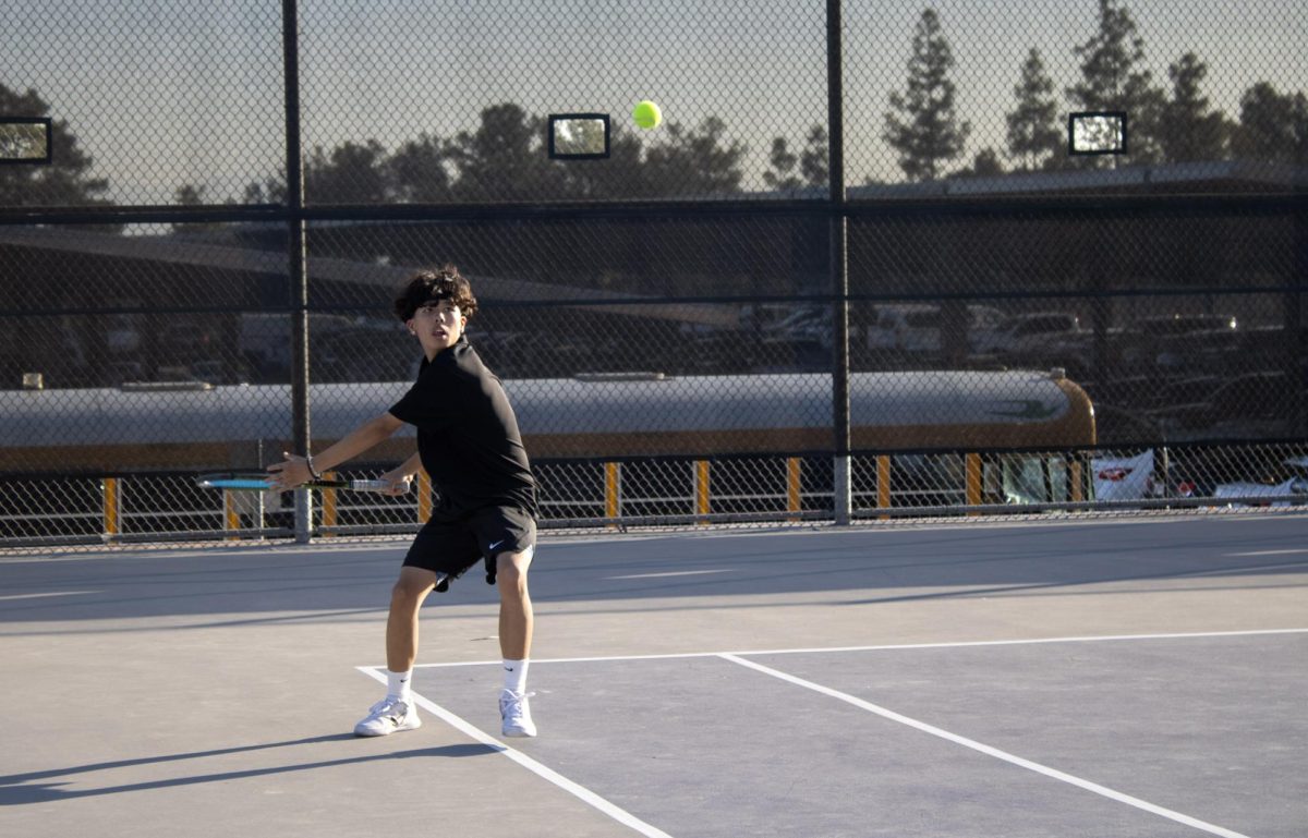 Sophomore Ethan Hou prepares to hit a forehand to his opponent.