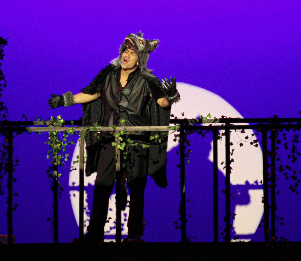 Senior Isaiah Chevy, portraying the Wolf, sings on stage and finishes his solo with a howl.