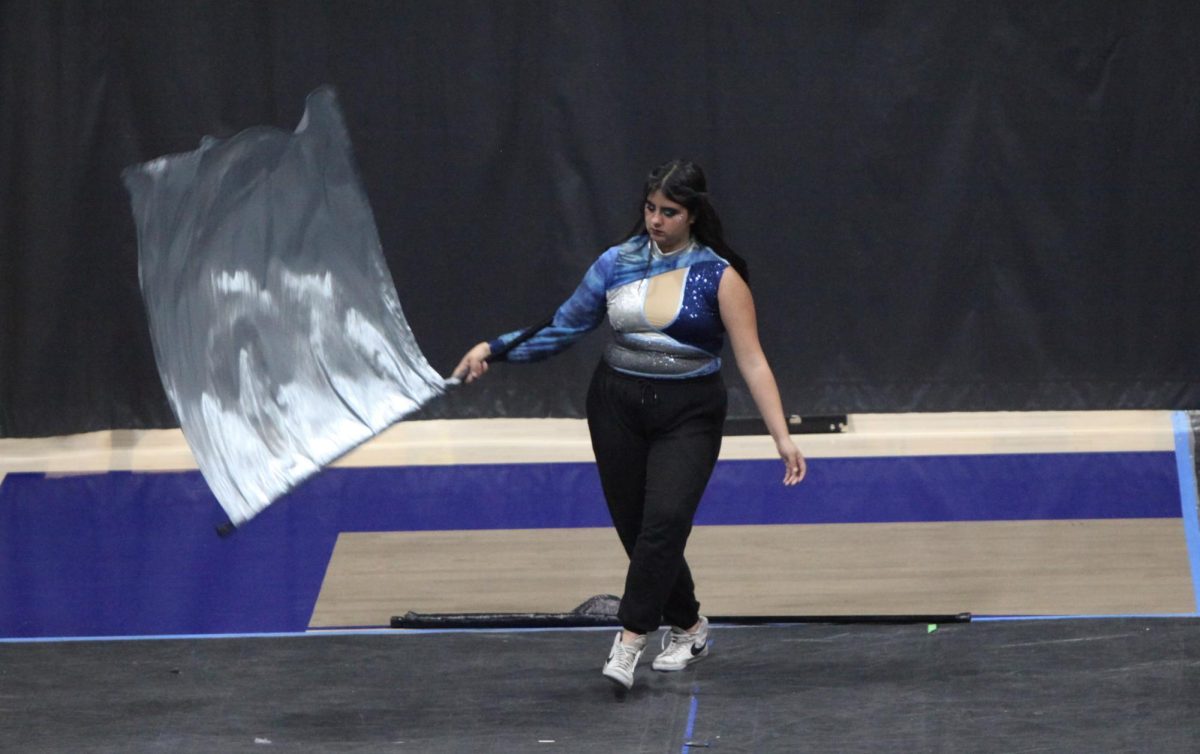 Junior Teanna Martens practices before Varsity Color Guard performs.