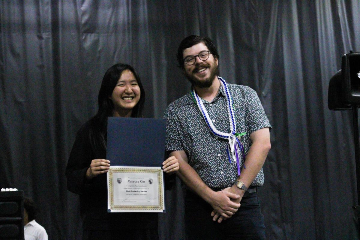 Junior, Rebecca Kim, is awarded "Most Outstanding Marcher" by instructor Chris.