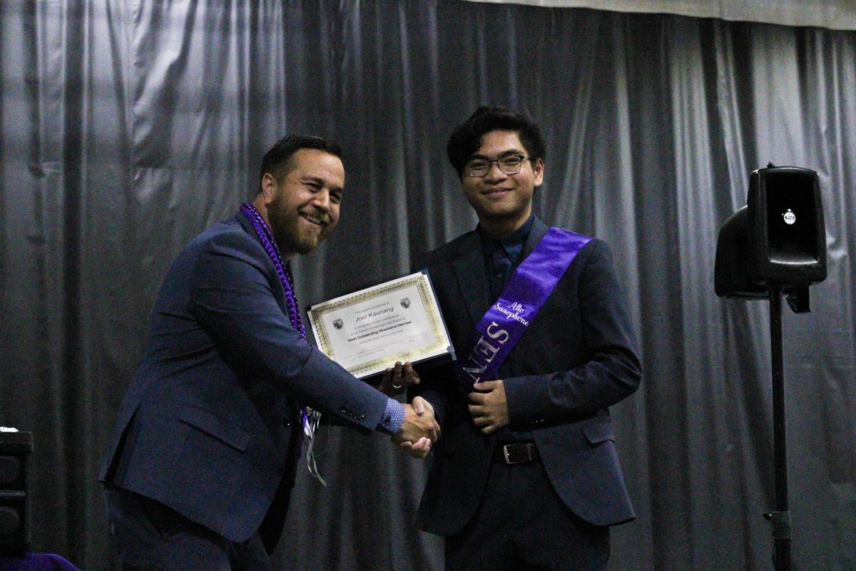 Senior, Joel Kaunang, receives the "Most Outstanding Woodwind Member" by band director Mr. James Ana.