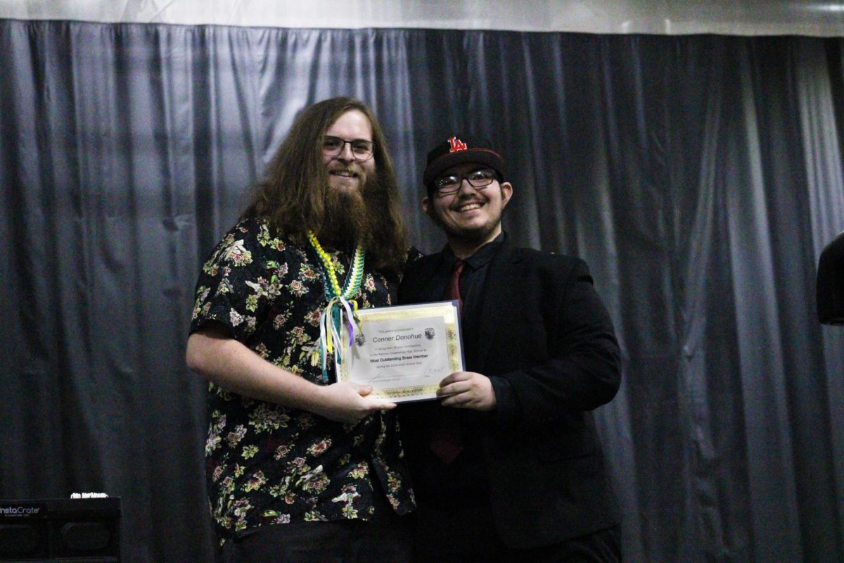 Senior, Conner Donohue, is awarded "Most Outstanding Brass Member" by his technician.