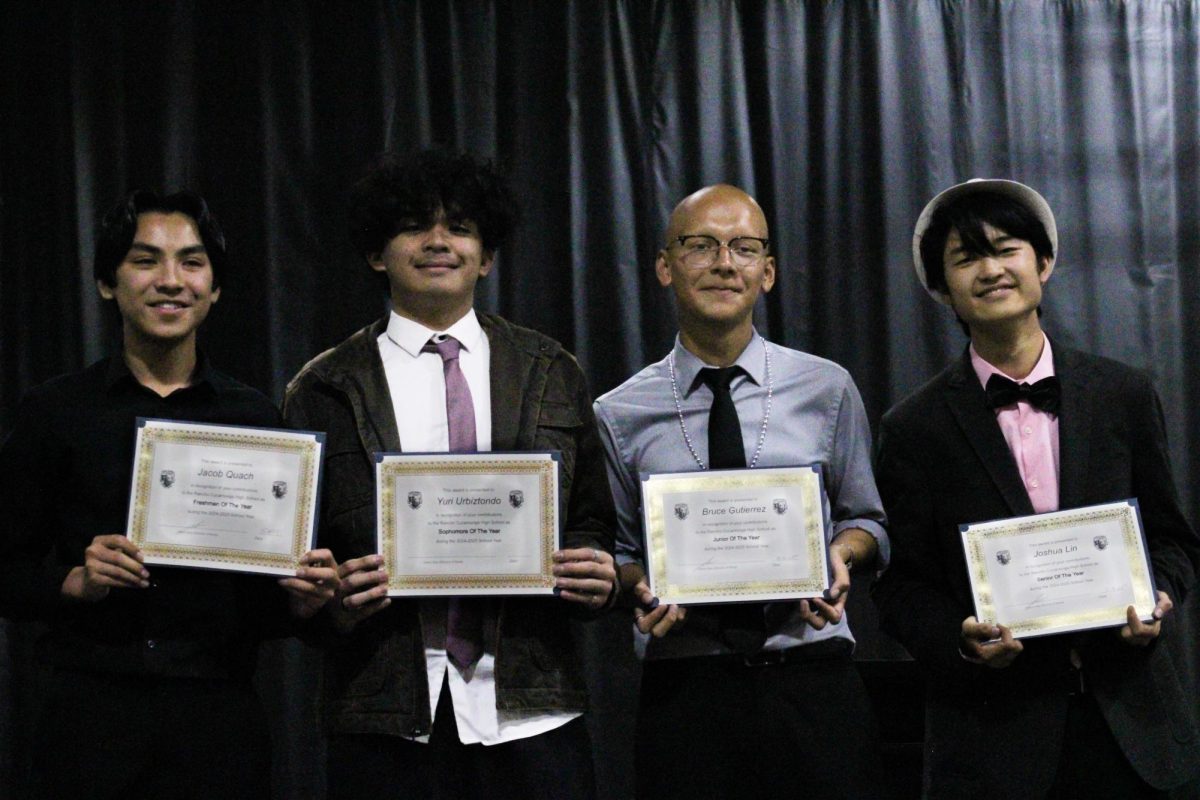 Freshman Jacob Quach, sophomore Yuri Urbiztondo, junior Bruce Gutierrez, and senior Joshua Lin smile together after receiving their class awards. 