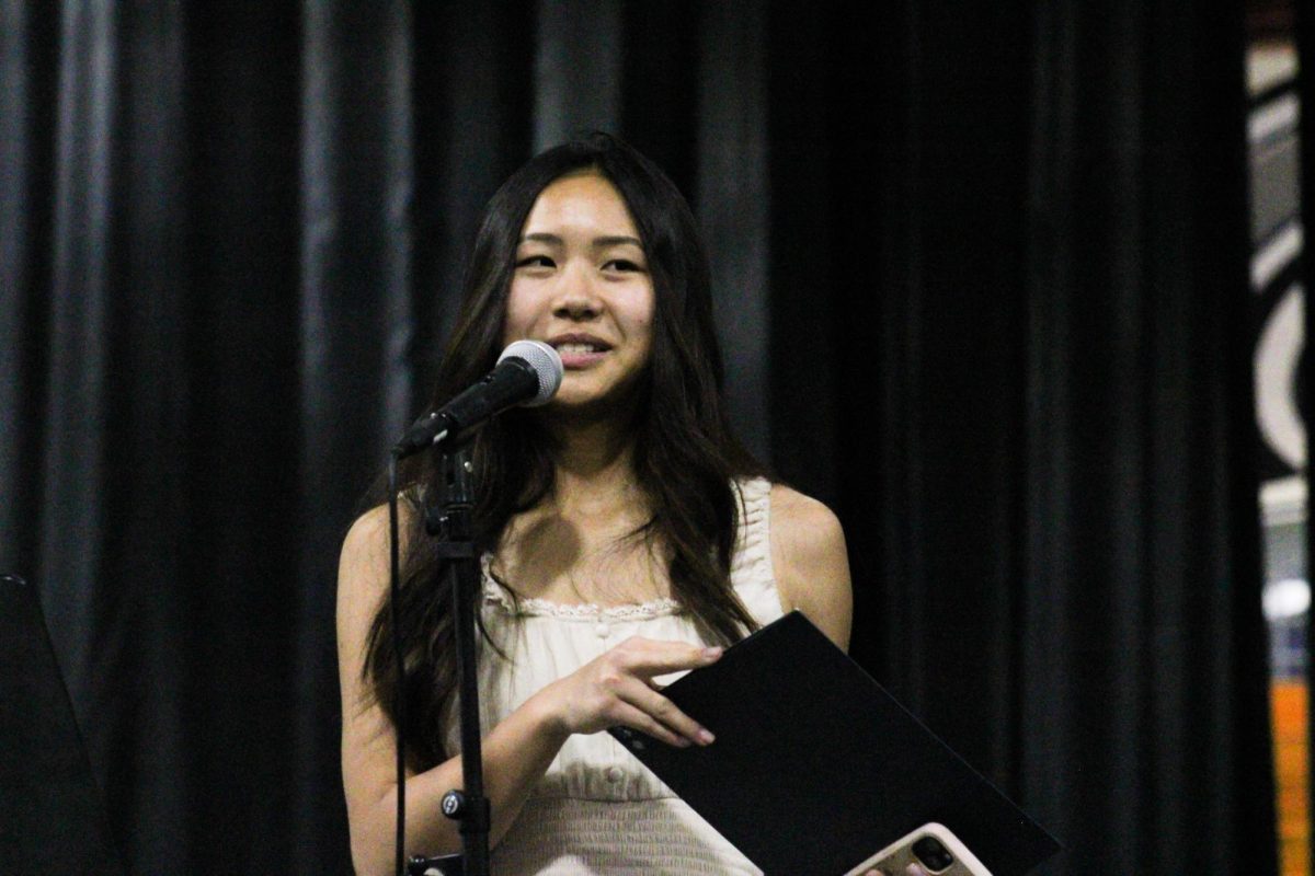 The percussion's front ensemble instructor, Shirley Taylor, introduces the award she is presenting.