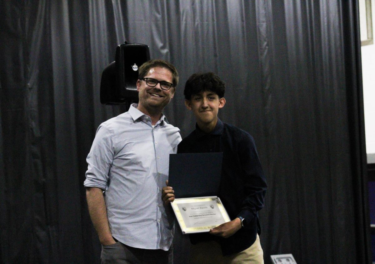 Senior, Miguel Zavala, is awarded "Most Outstanding Percussion Member" by his technician Eric Shriver.