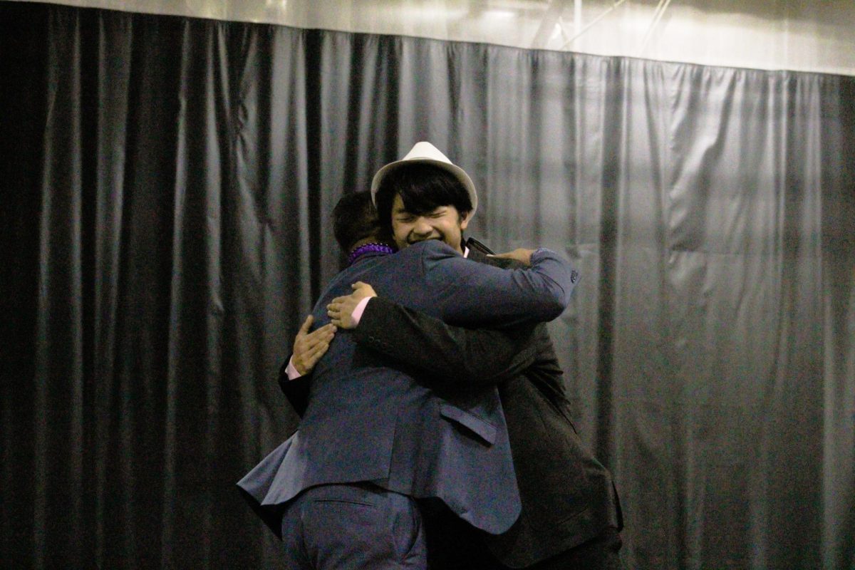Senior Joshua Lin hugs his director after receiving his award.